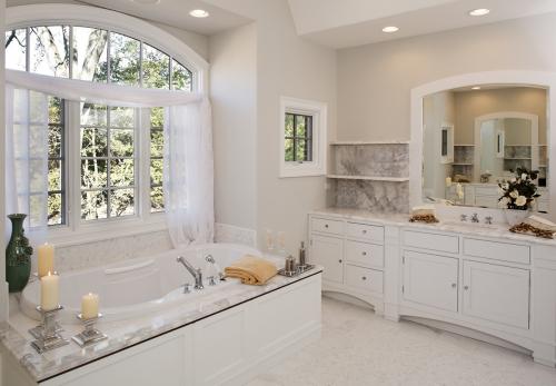 Custom white toned master bathroom with jacuzzi tub.